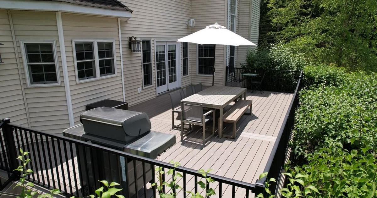 Covered porch and deck beside a paver patio in the Hudson Valley