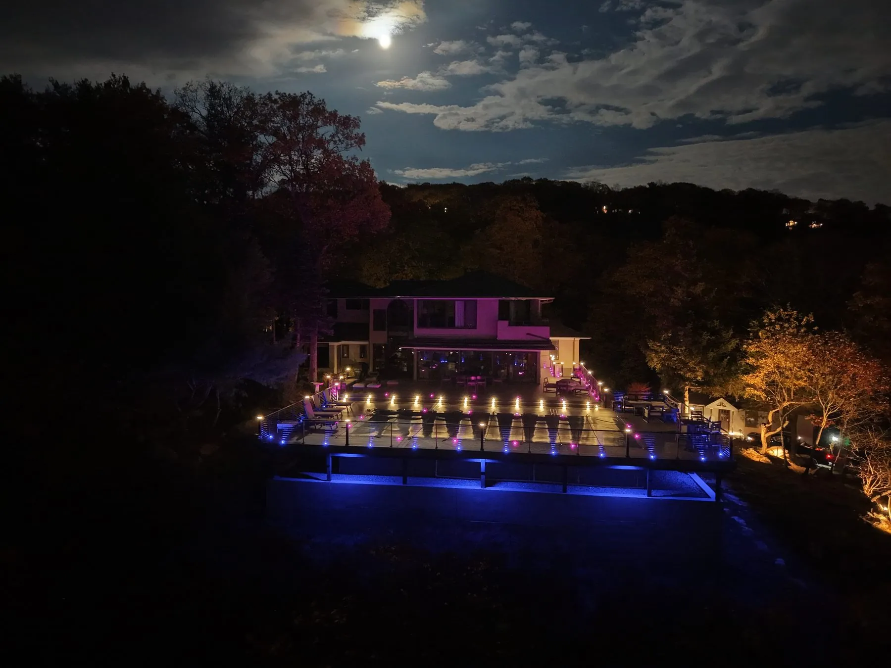 Moonlit aerial of a luxury Trex deck estate with pool — Pinnacle Decking Hudson Valley NY