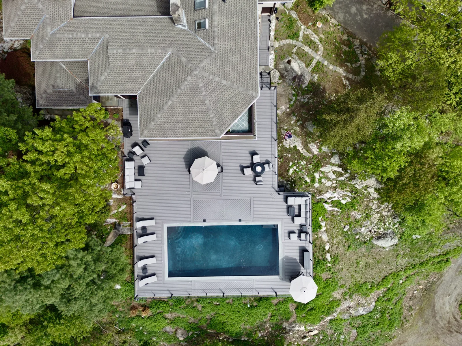 Sunlit hillside pool deck — full-sun exposure where heat mitigation matters