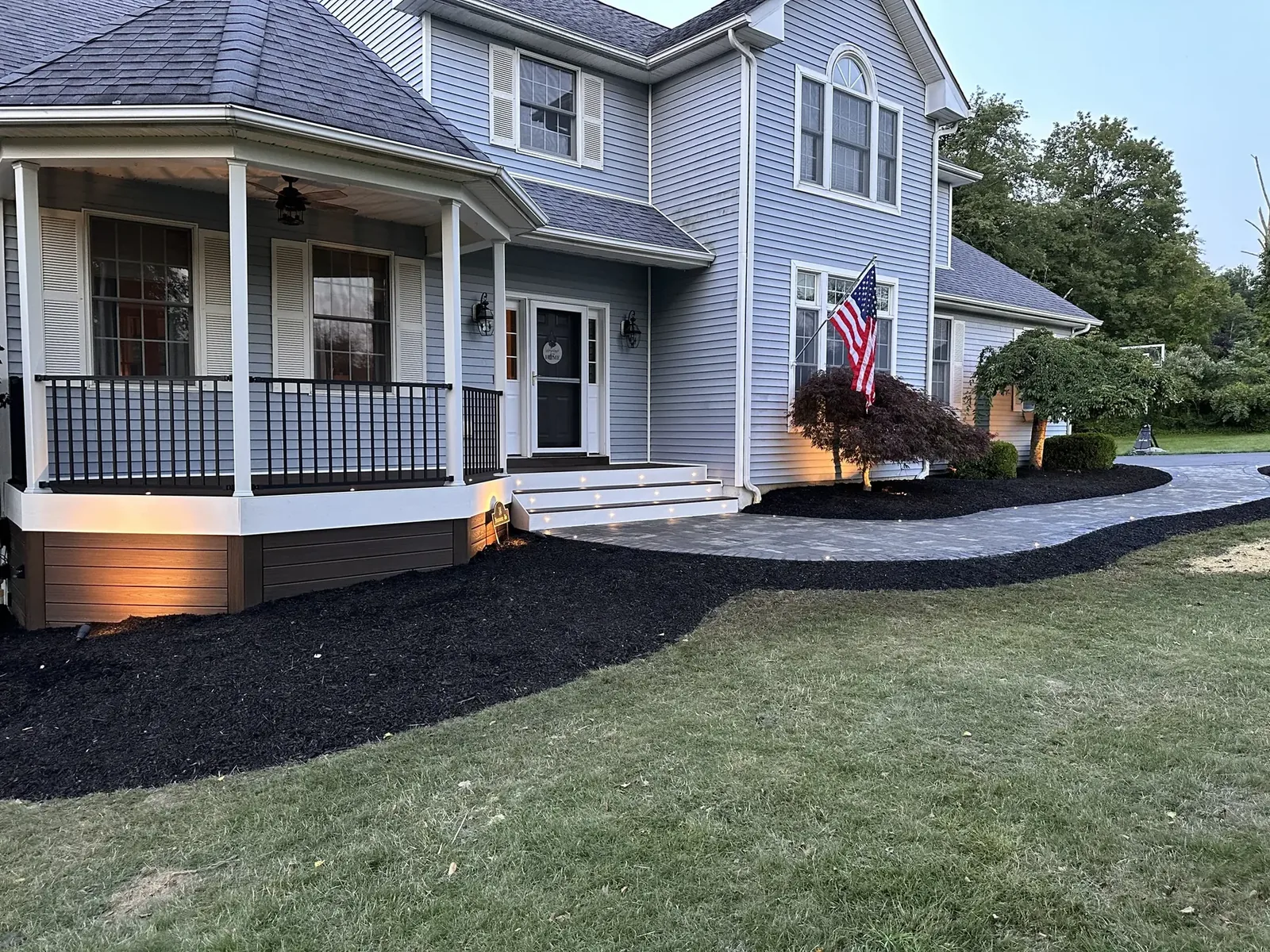 Covered porch and outdoor living at dusk — three-season Hudson Valley use