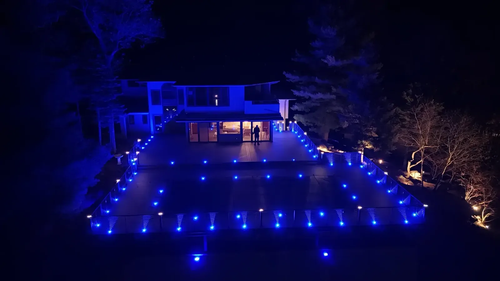 Outdoor living patio with blue LED lighting at night