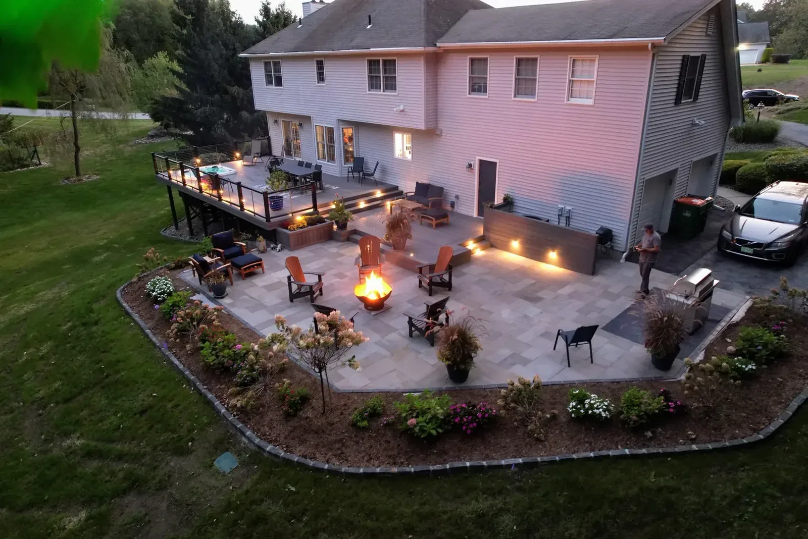 Finished paver patio and fire pit lit at night
