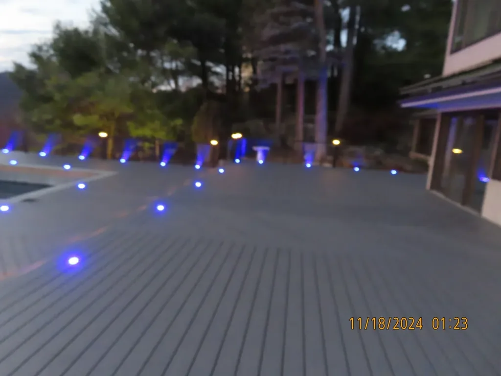 Deck posts with blue LED post lighting at dusk