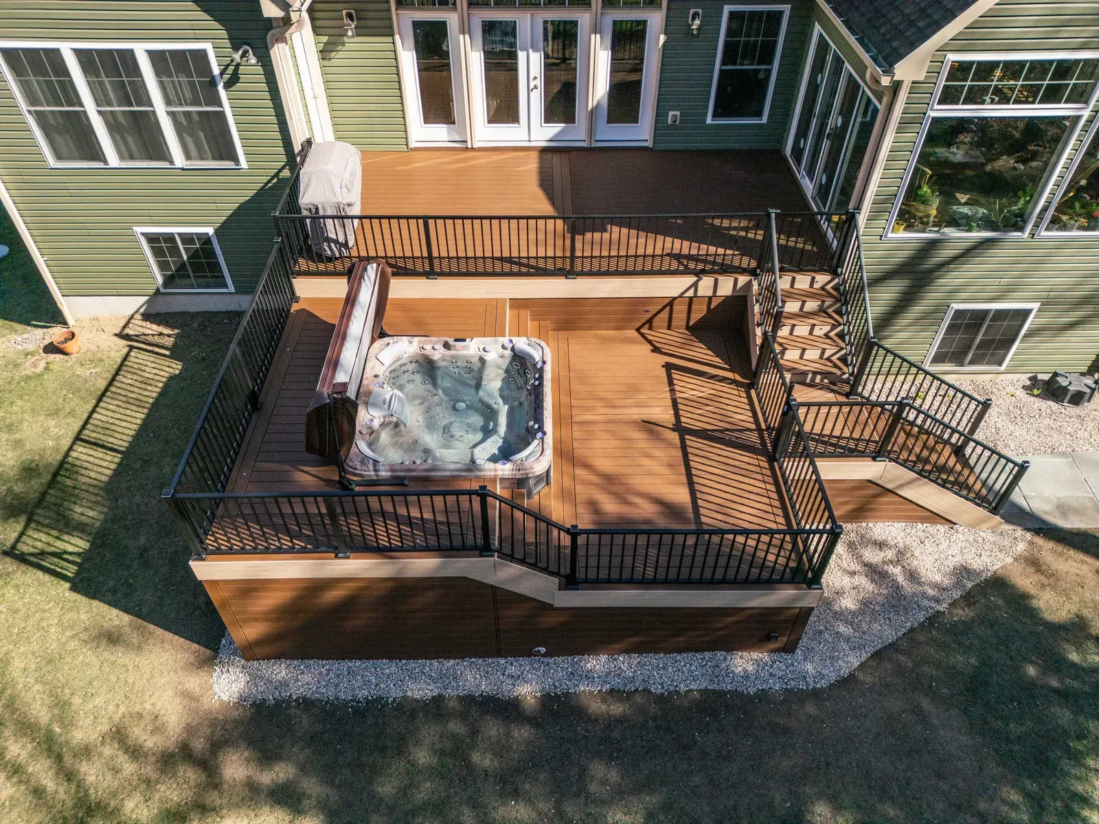 Composite deck with hot tub, pergola, and seating
