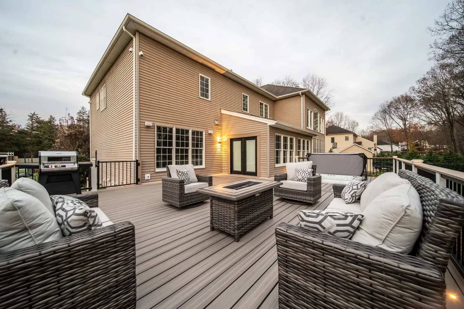 Finished deck with fire table and lounge seating in evening light