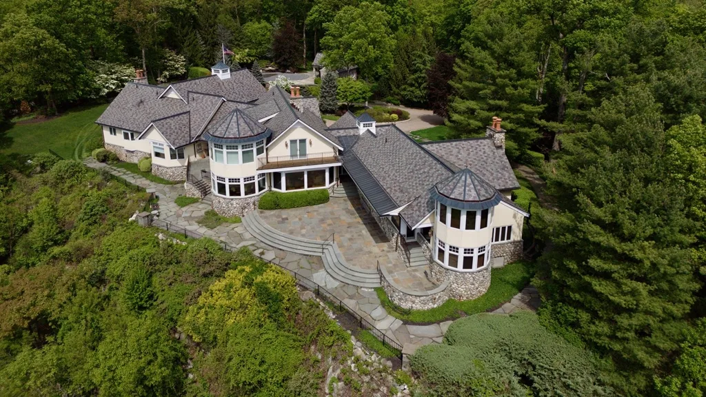 Aerial of a hilltop stone estate with bluestone patio