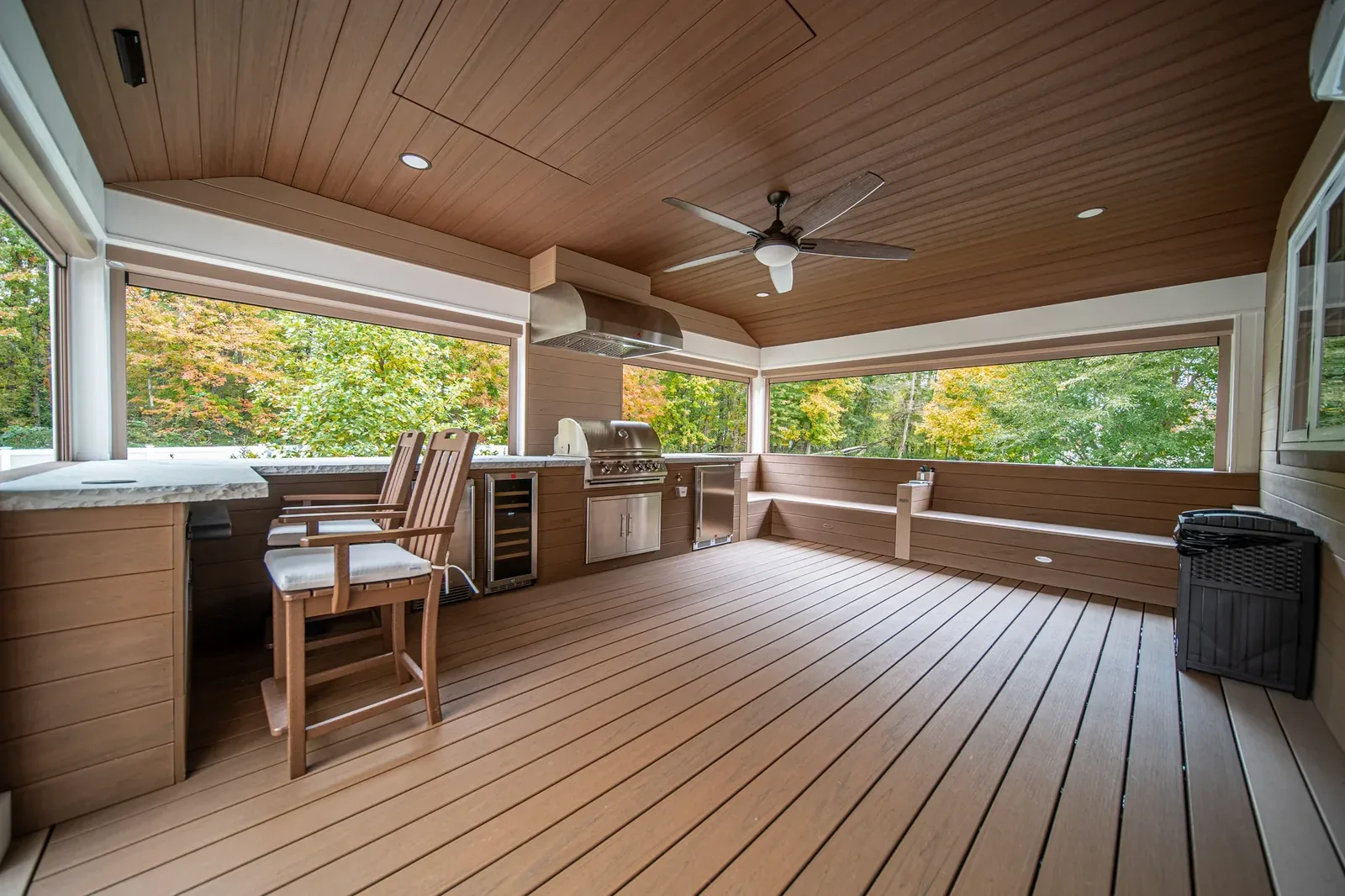 Covered outdoor living room with a continuous run of deck boards underfoot
