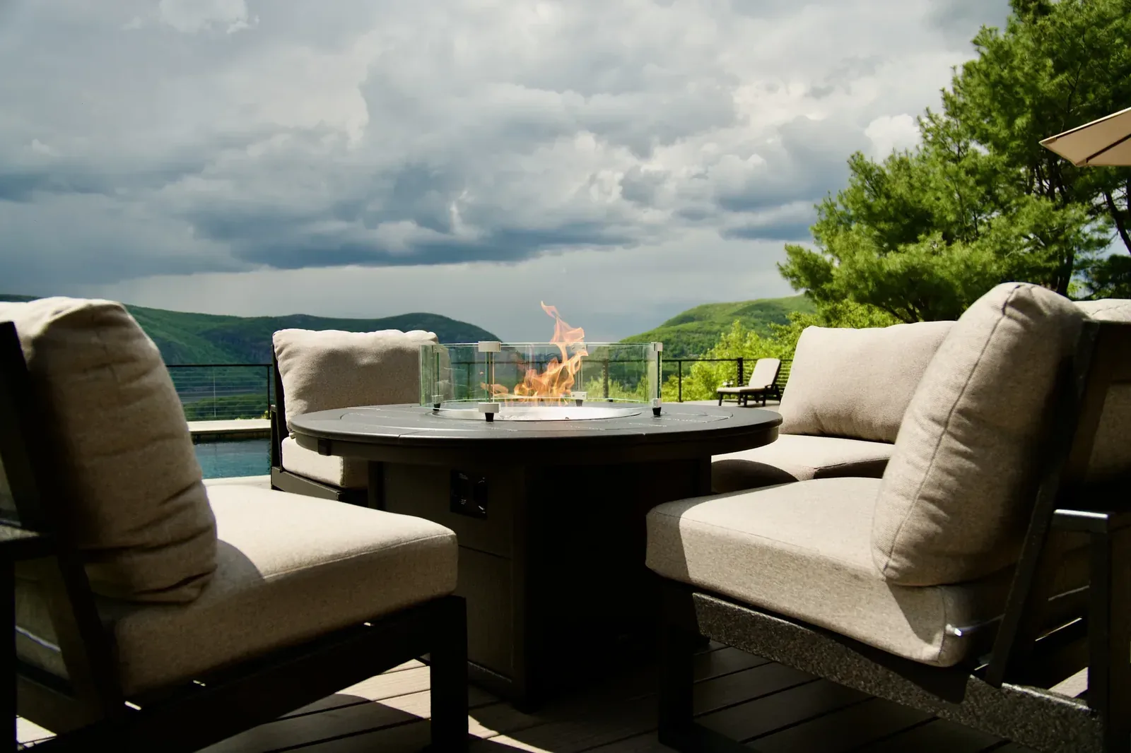 Multi-level composite pool deck on a wooded Hudson Valley hillside