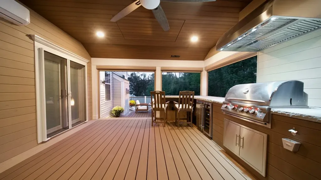 Covered outdoor kitchen with warm lighting at dusk