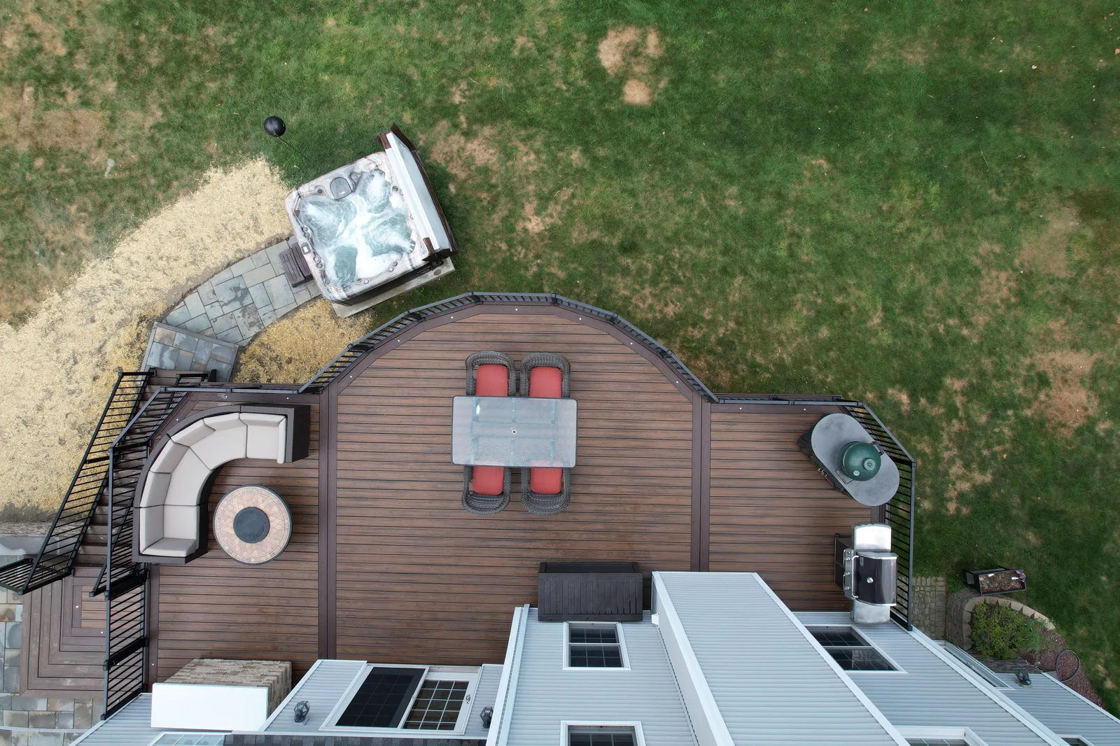 Overhead outdoor living deck layout with dining, lounge, stairs, grill, and hot tub