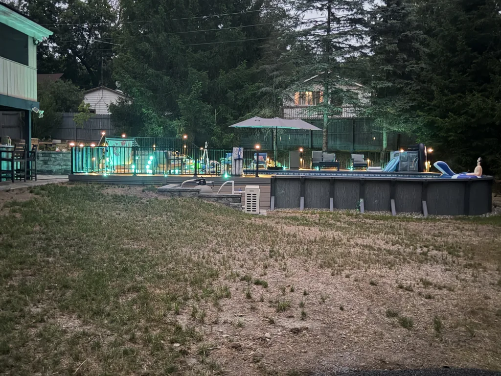 Dusk pool deck with teal accent lighting