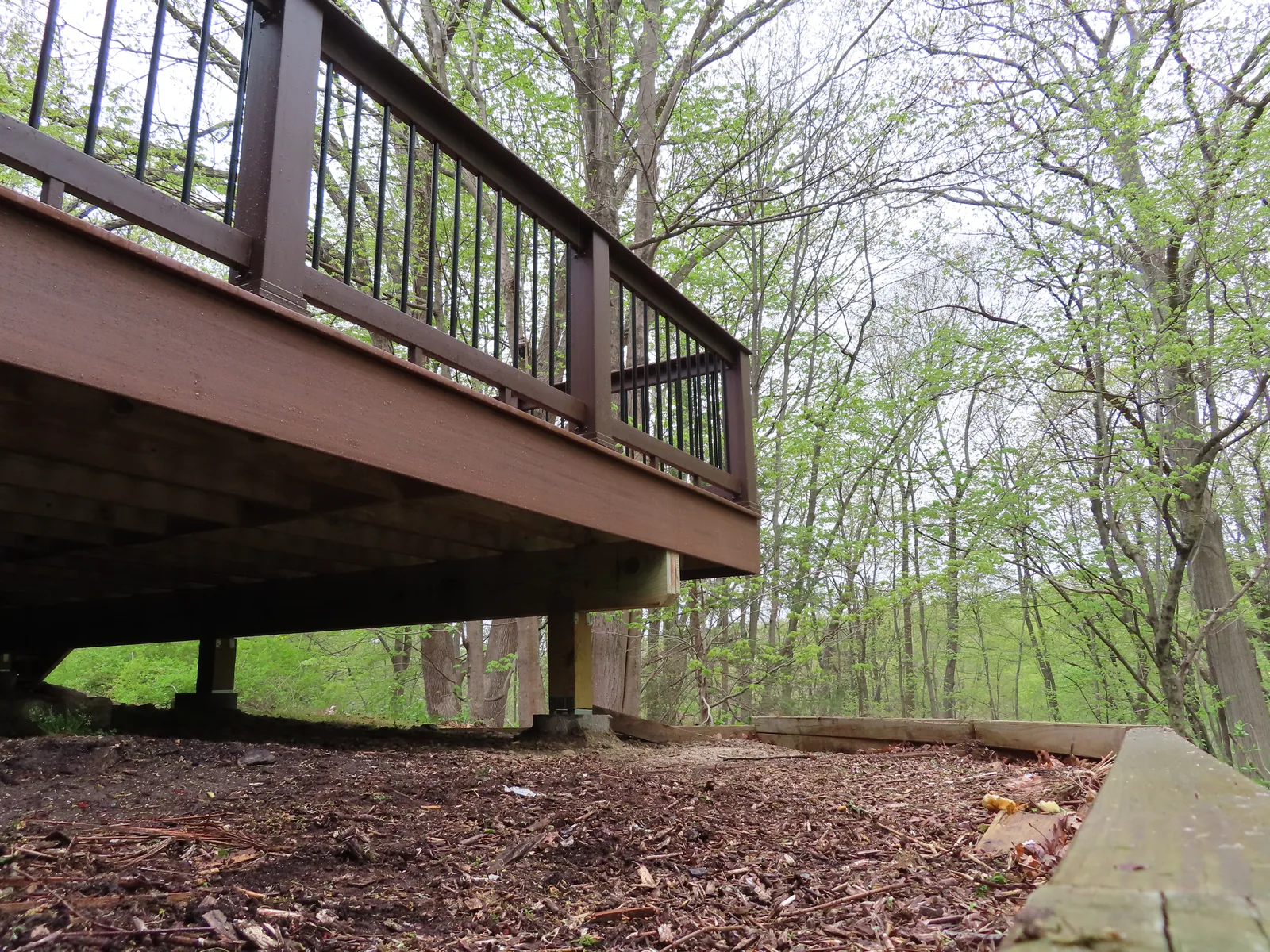 Elevated deck structure clear of the ground plane — how bridge footings keep load off tanks