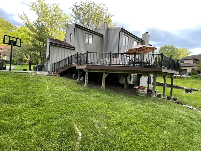 Raised deck with black railing and stairs, Scarsdale, NY