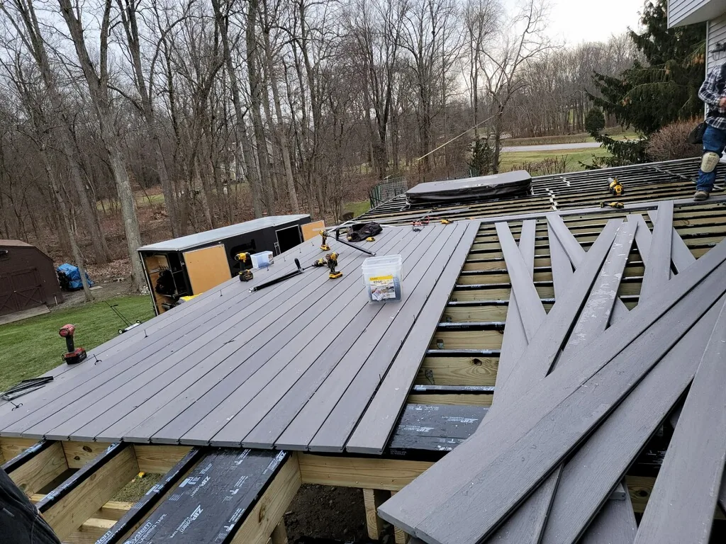Decking going down over the engineered frame, inlay boards staged