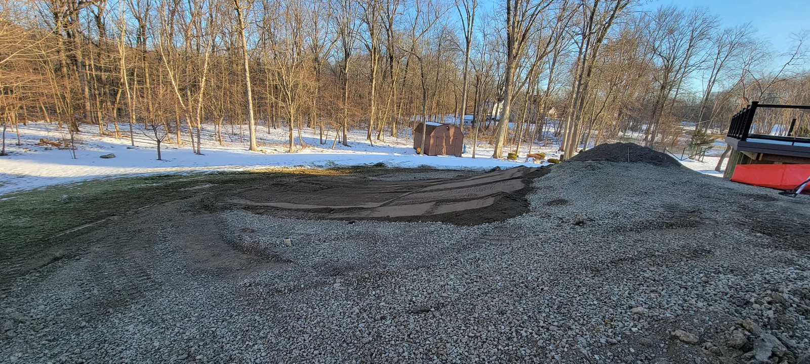Backyard grade raised with imported fill and gravel before the patio build
