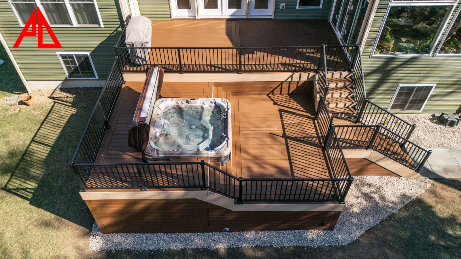 Overhead view of a two-level Trex Select deck with integrated spa, grill station, and lit stairs