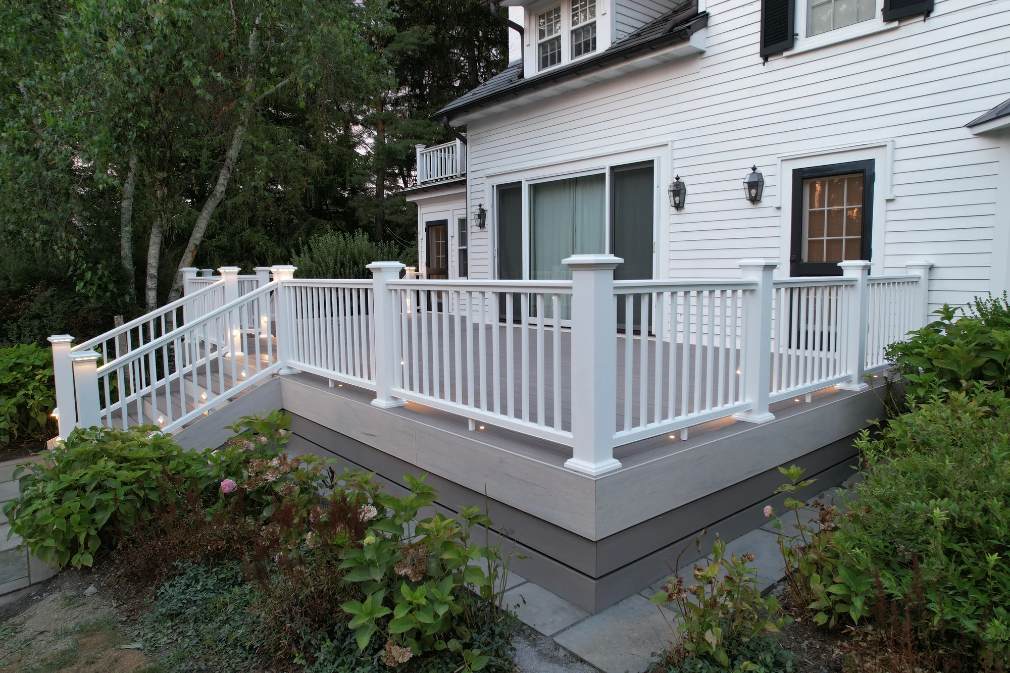 Signature railing post-cap lighting close-up at dusk