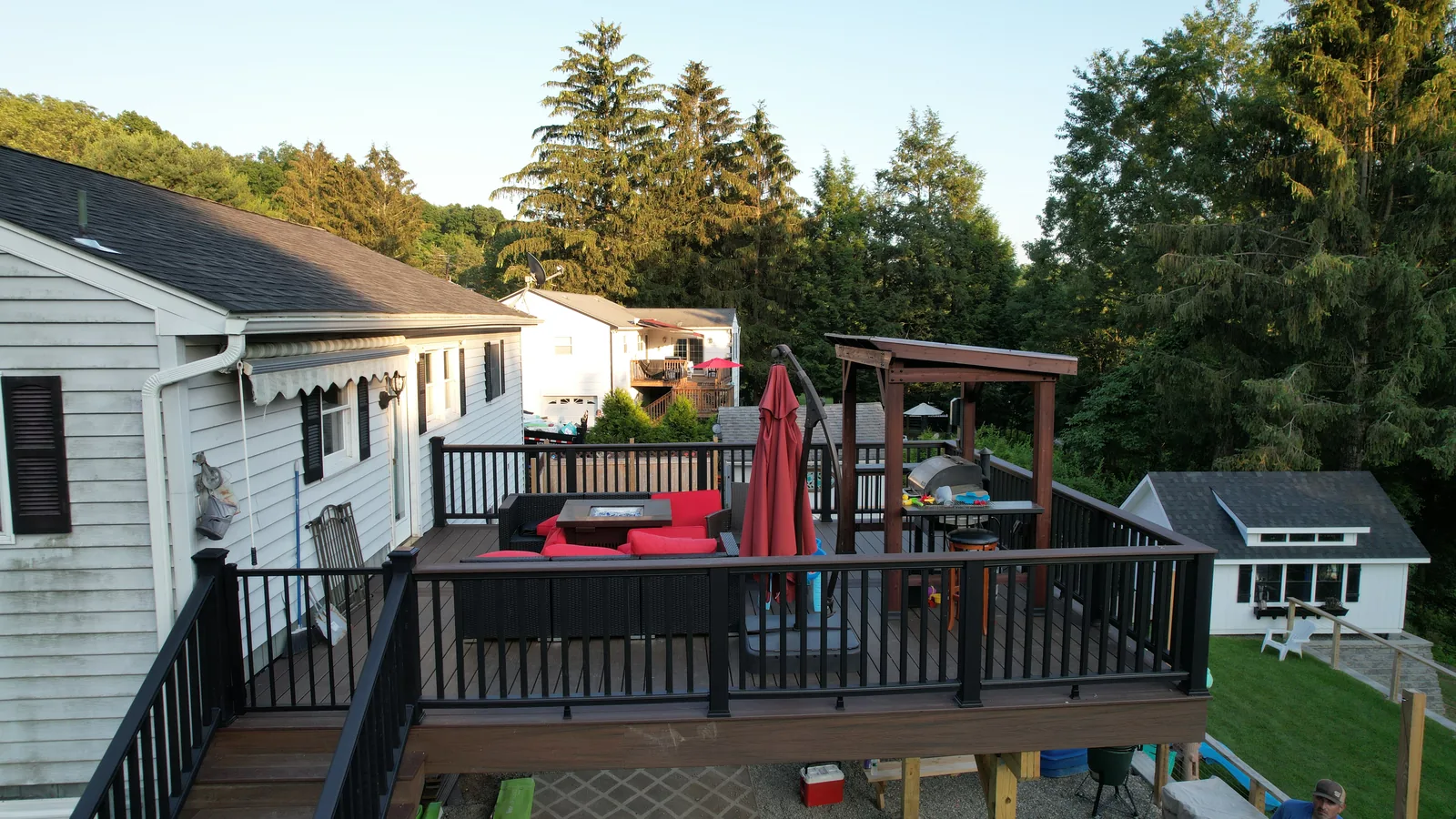 Raised deck lounge and dining area at golden hour in Putnam County, NY