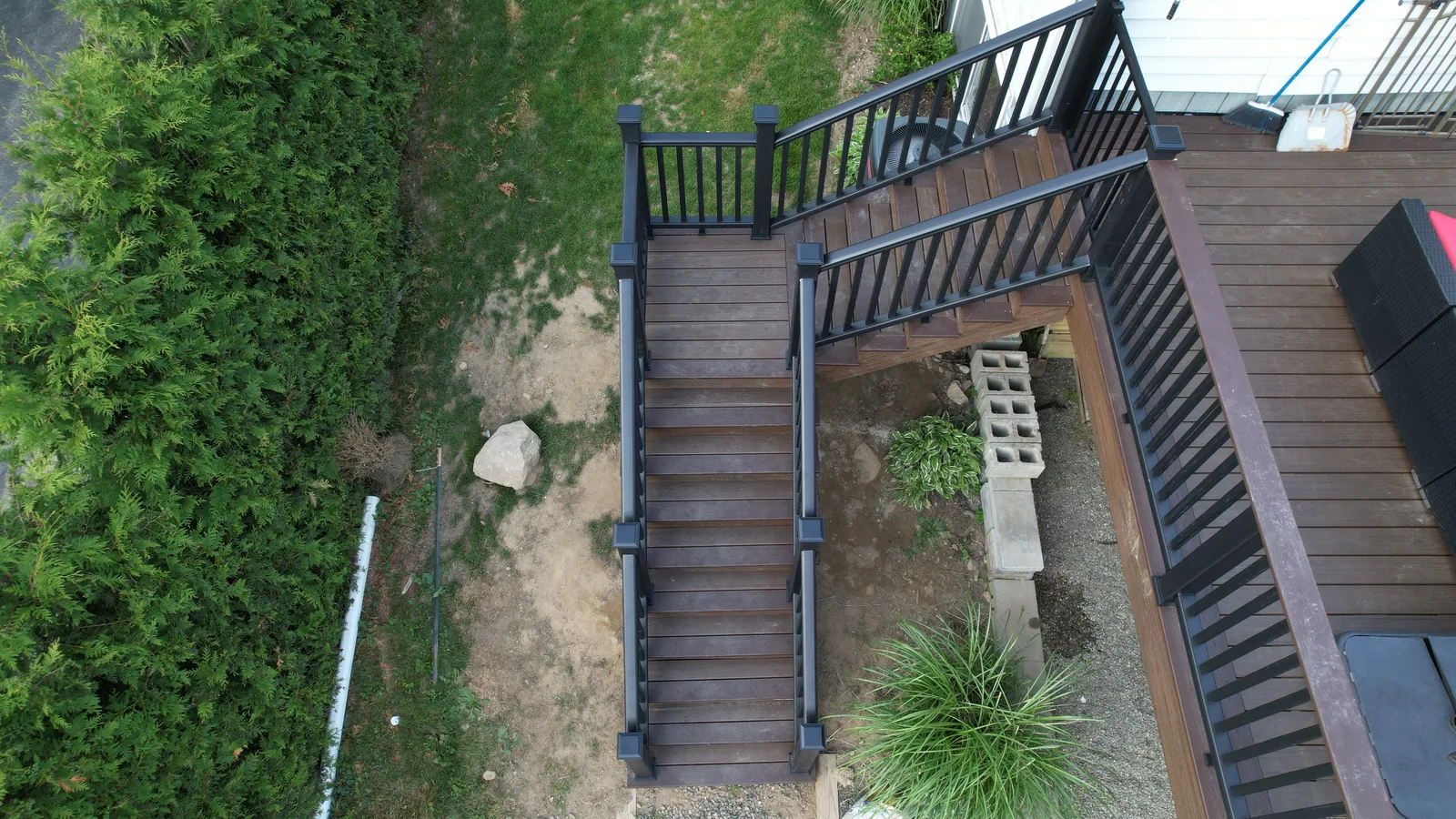 Aerial view of an elevated deck staircase and landscaping in Putnam County, NY