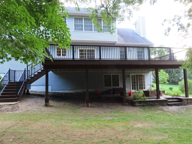 Elevated deck with black railing and stairs