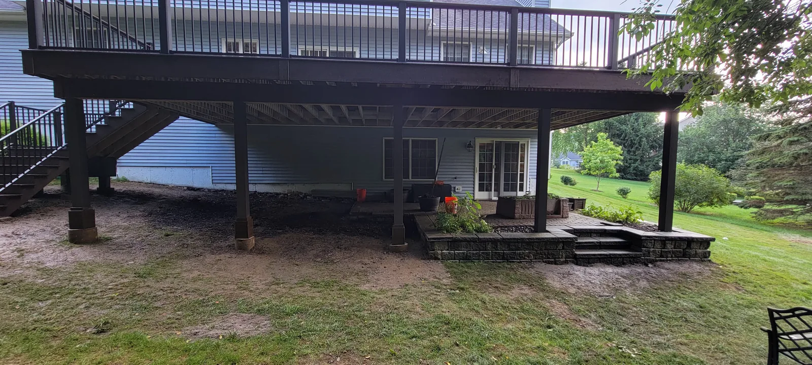 Elevated deck over a stone patio and fire area in the Hudson Valley, NY