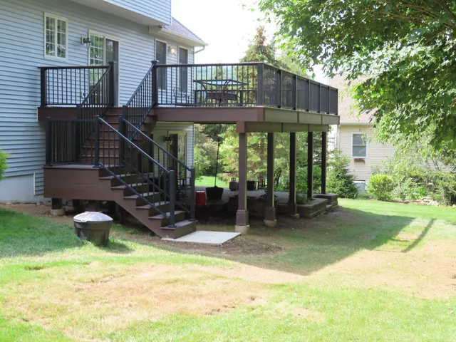 Elevated deck with black railing and stairs