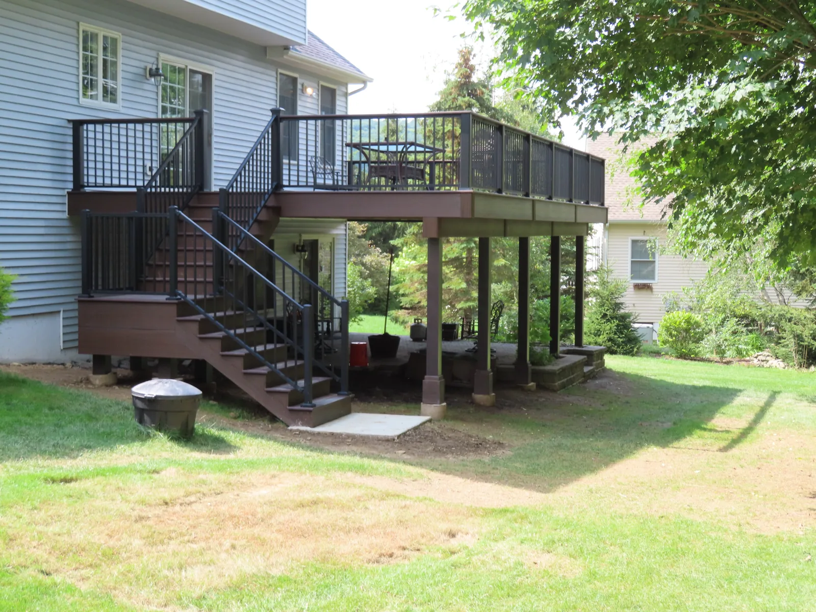 Elevated composite deck with staircase and black railing in the Hudson Valley