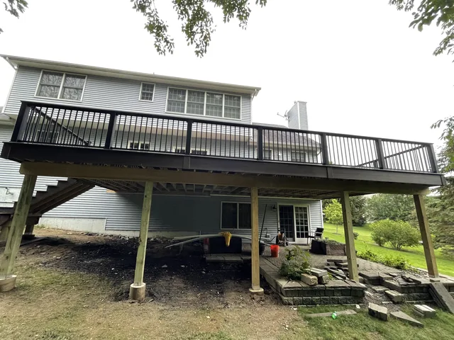 Elevated deck with black railing and stairs