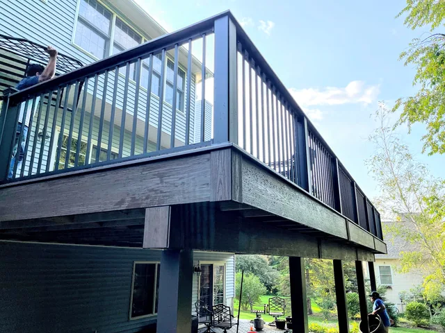 Elevated deck with black railing and stairs