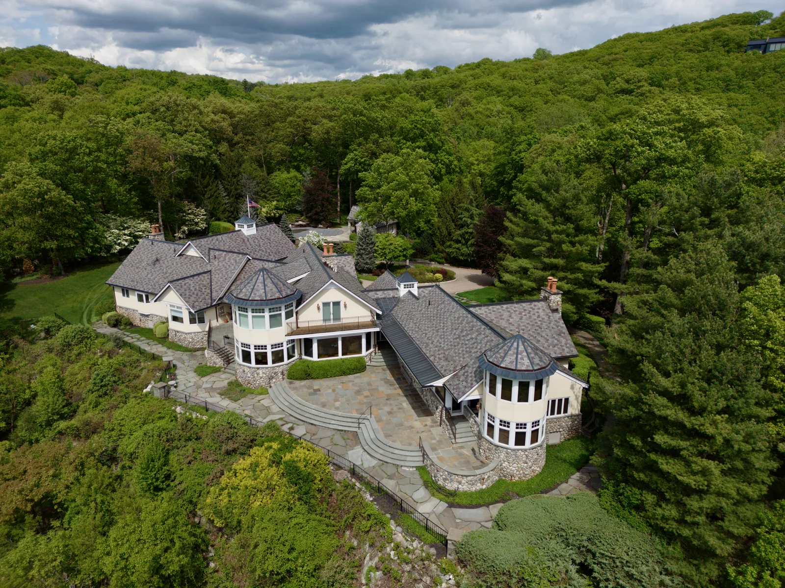 Drone aerial of estate property set into forested Hudson Highlands in Garrison, NY