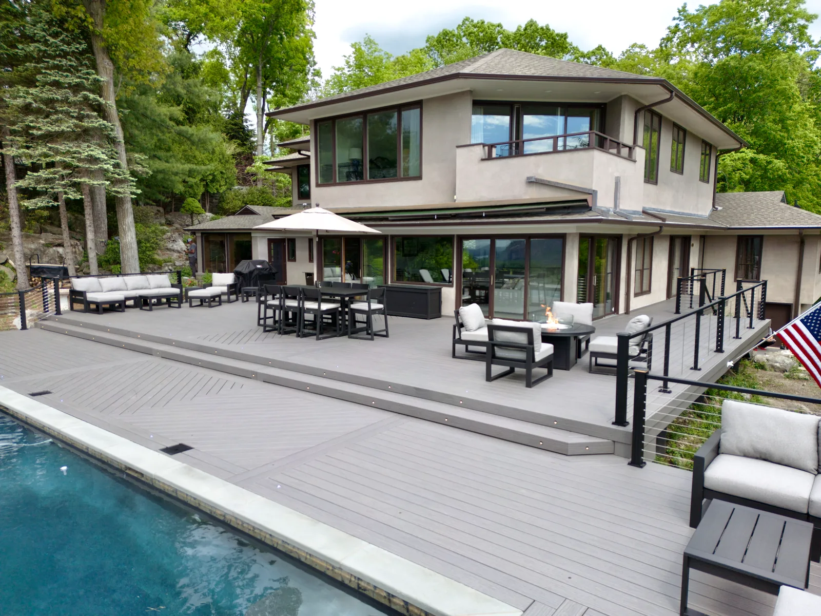 Composite pool deck with outdoor dining and Hudson Highlands views in Garrison, Putnam County