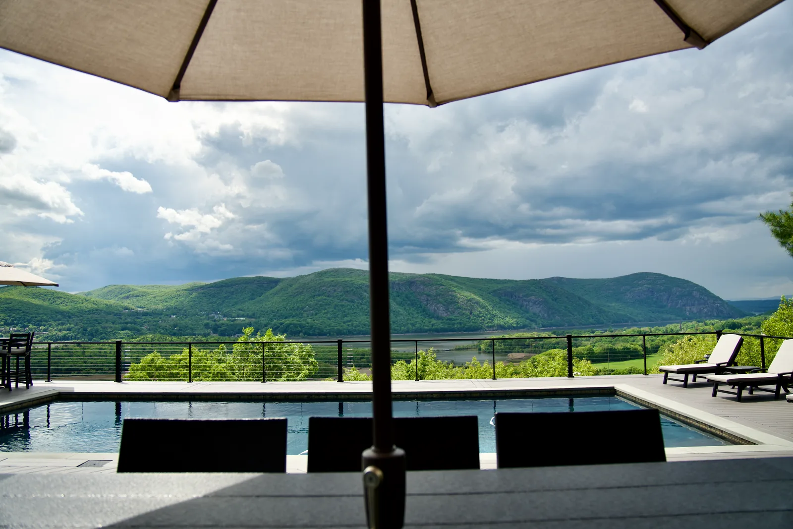Framed view of Hudson Highlands from poolside umbrella in Garrison, NY