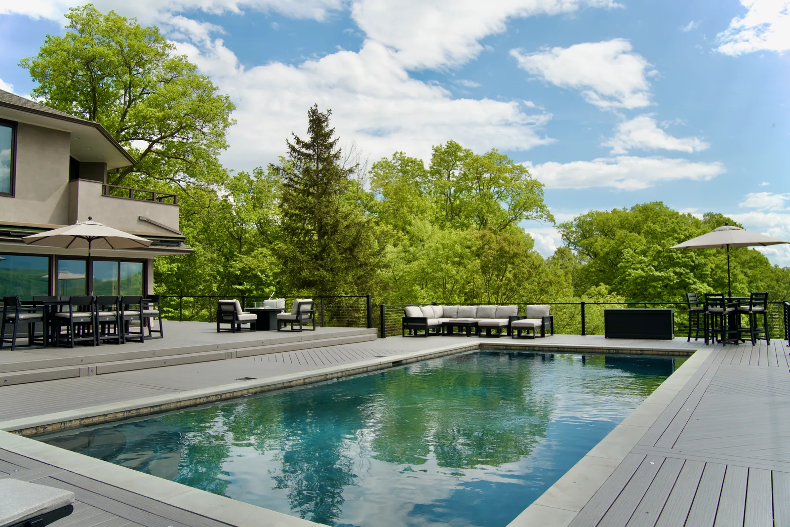 Pool with sectional lounges and Signature cable railing in Garrison, NY