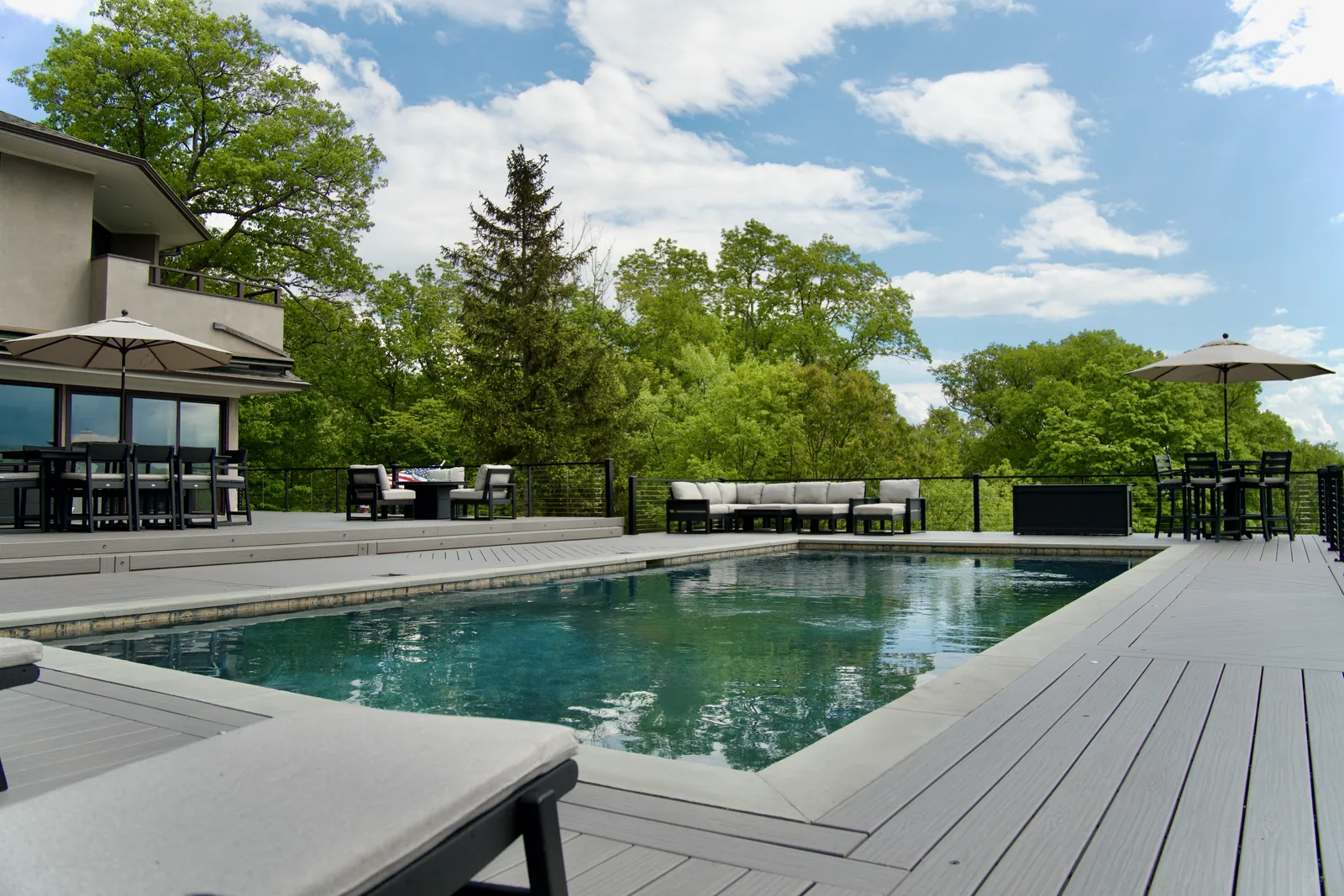 Composite pool deck with cable railing and open Hudson Highlands mountain views in Garrison, NY