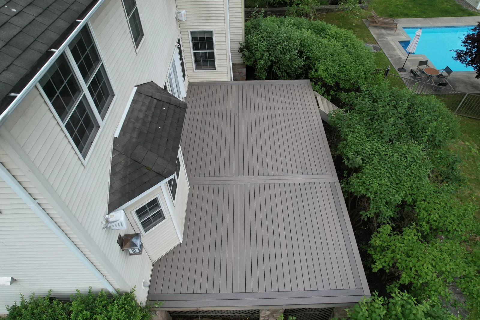 Overhead aerial of a backyard deck beside a pool in the Hudson Valley, NY