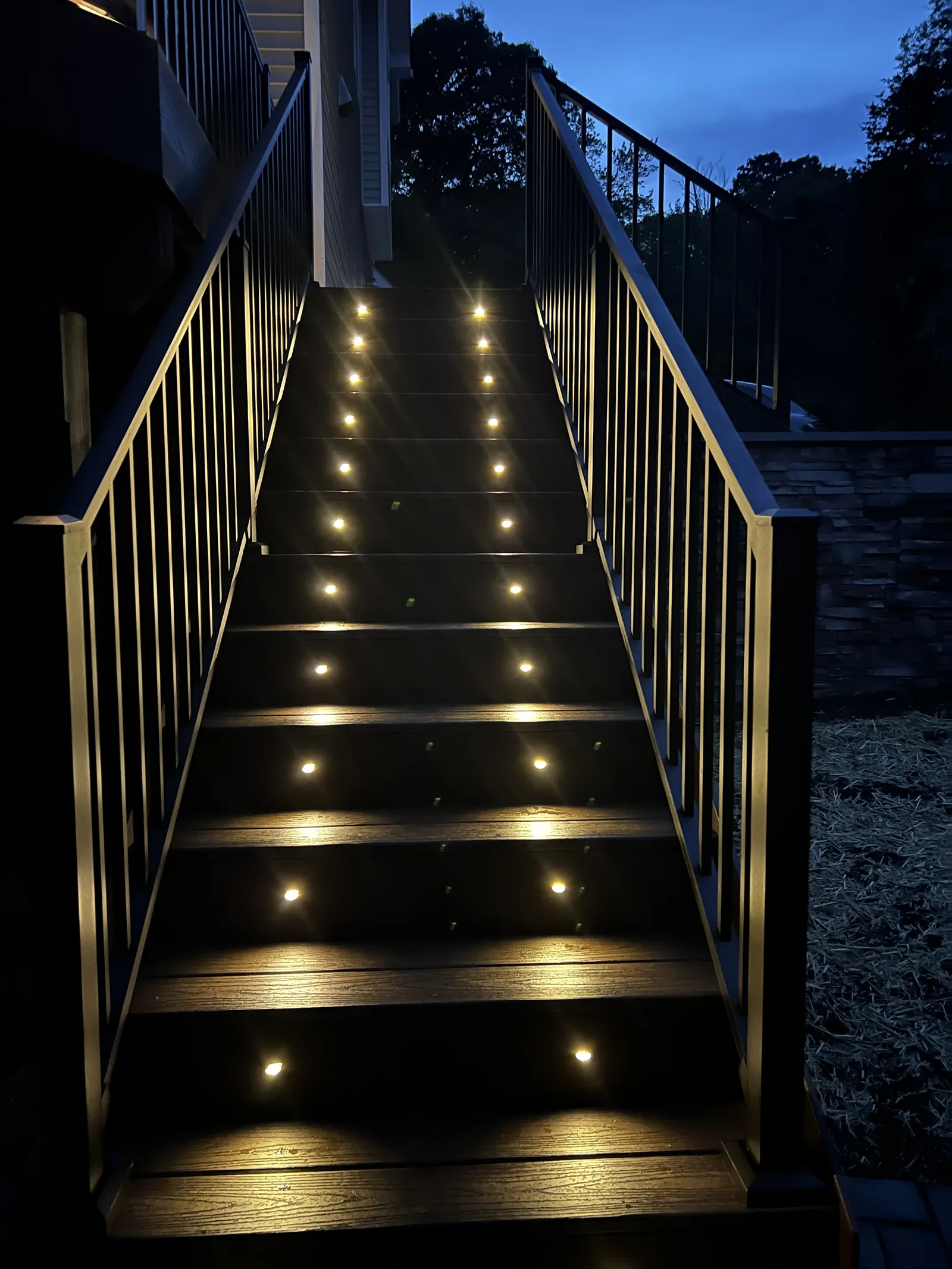 Twilight deck staircase with illuminated riser lights in the Hudson Valley, NY
