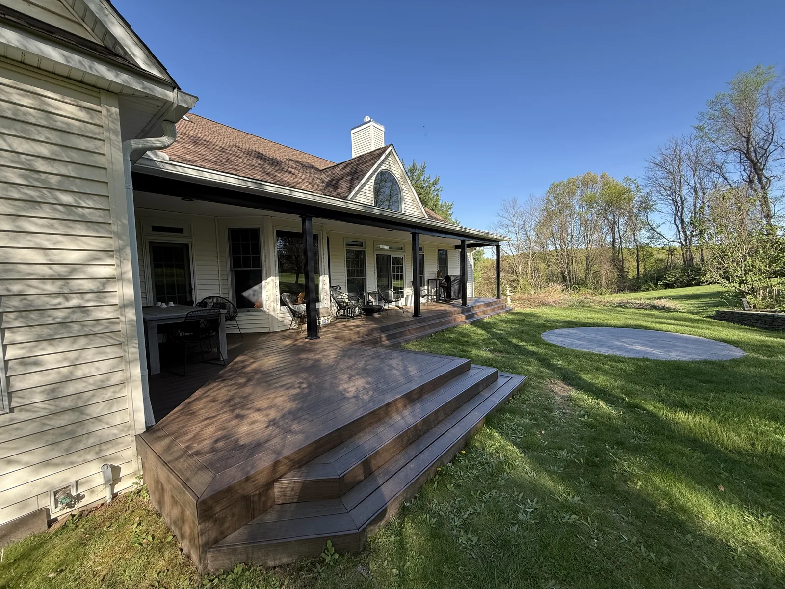 Deck with wrapping stairs in golden light in Hyde Park, NY