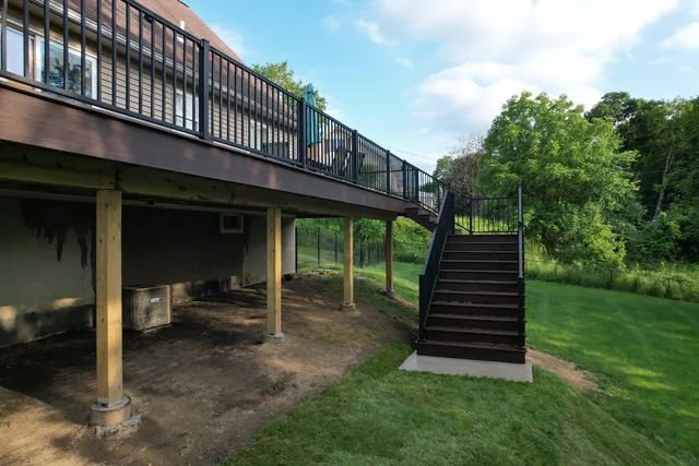 Elevated deck with black railing and long stairs