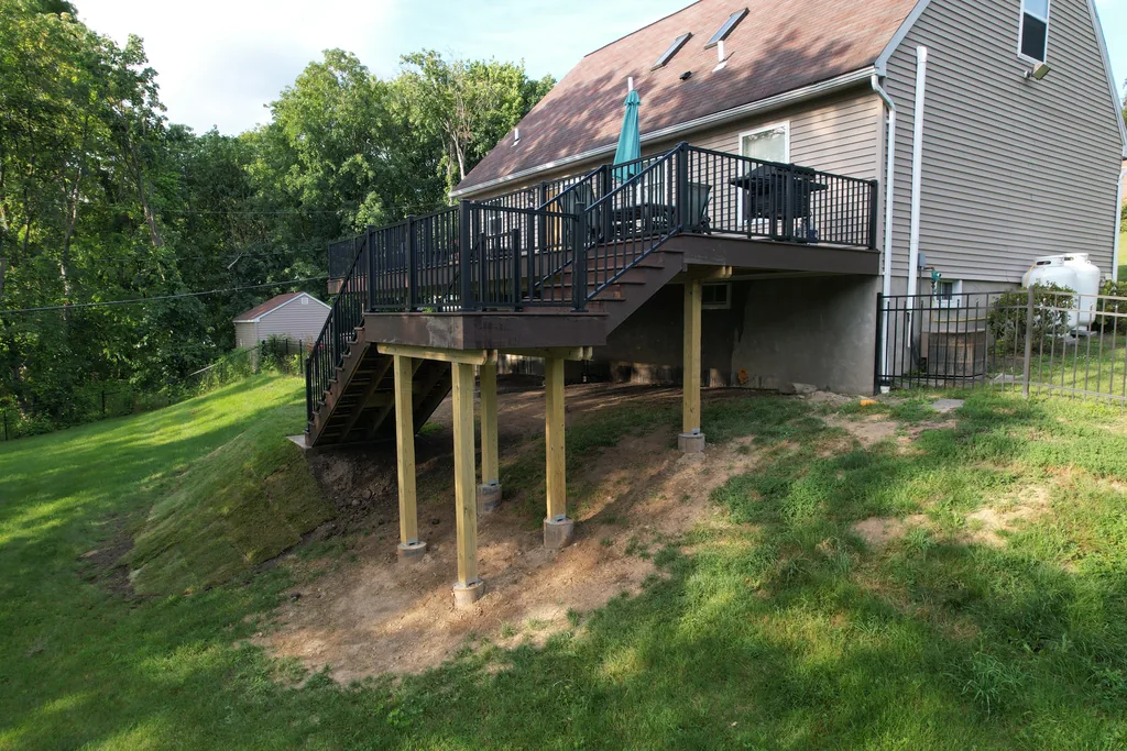 Composite deck on elevated terrain engineered for Hudson Valley conditions