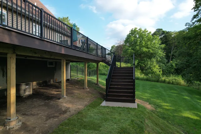 Elevated deck with black railing and long stairs