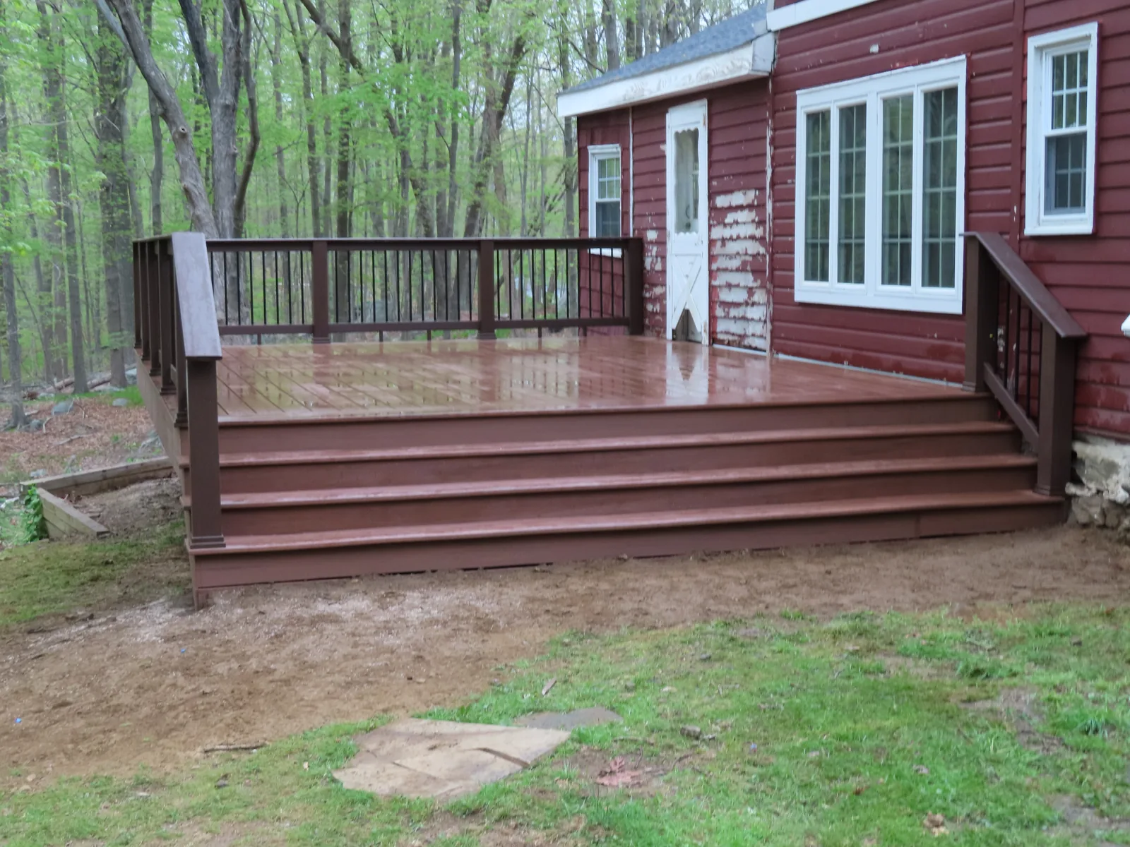 Finished composite deck with wide steps and railing in Putnam County, NY