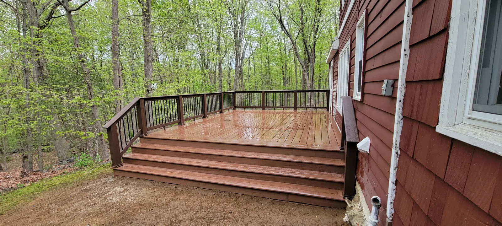 Wraparound deck and railing at the wood's edge in Putnam County, NY