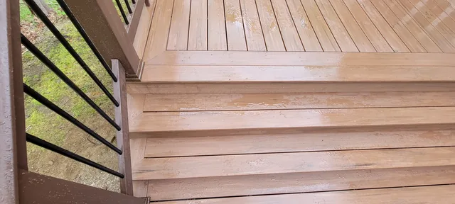 Composite deck with dark railing on a wooded lot, Putnam County