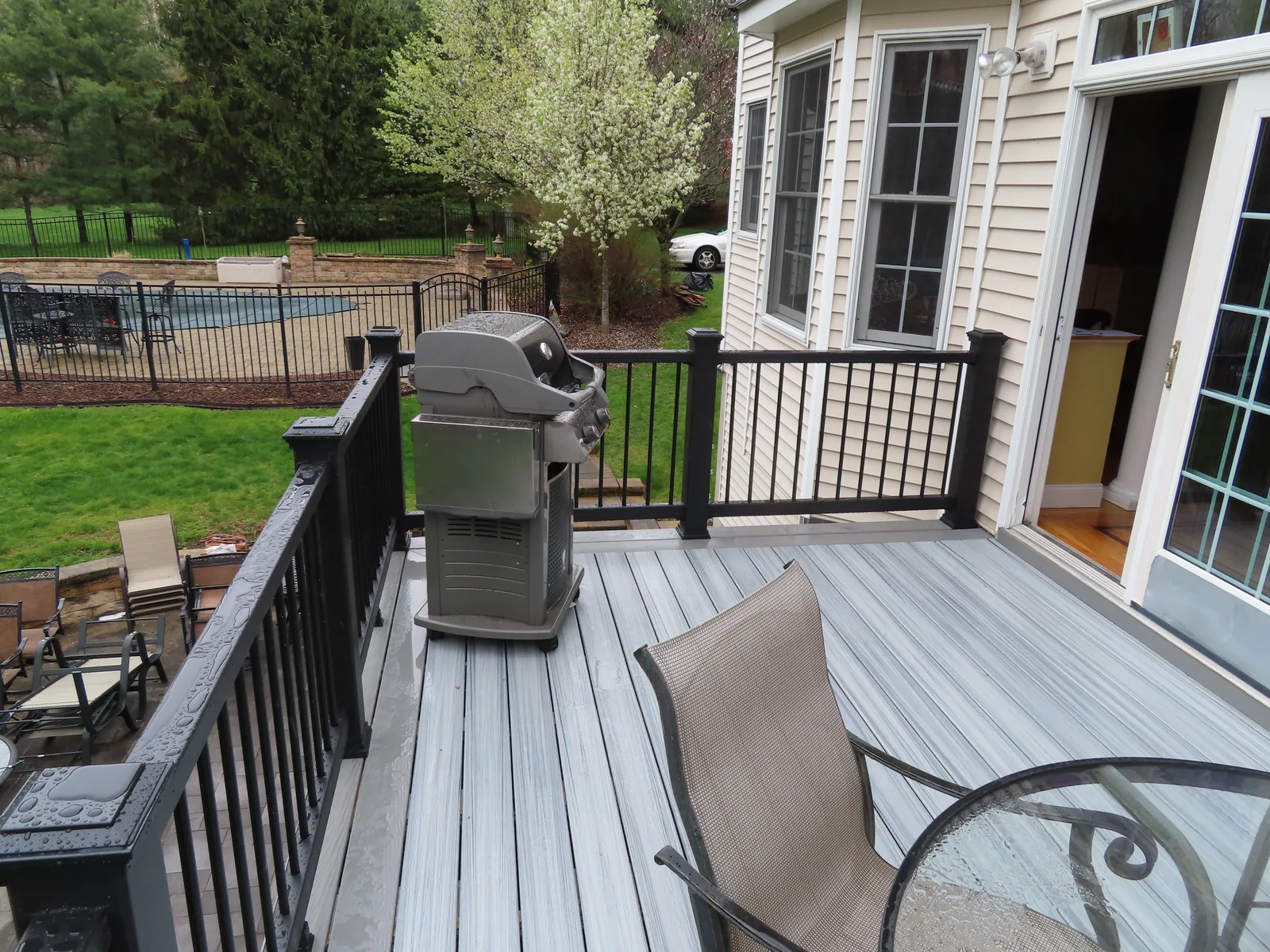 Deck lounge with a grill and a pool beyond on the Renaldi project, Hudson Valley NY