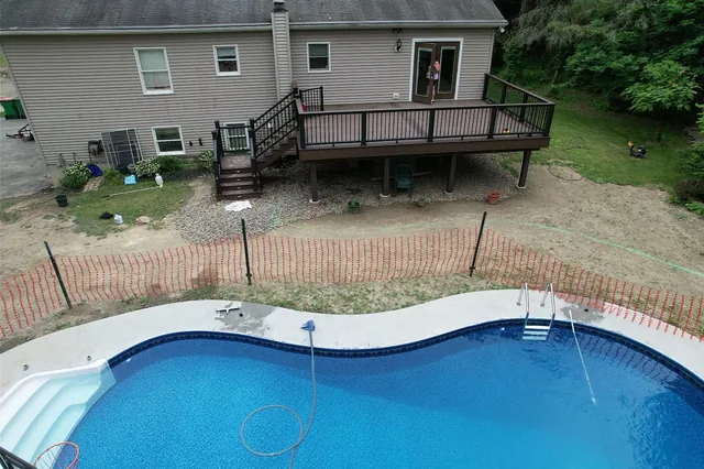 Deck with black railing above a backyard pool, Verbank, NY
