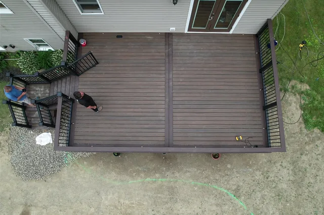 Deck with black railing above a backyard pool, Verbank, NY