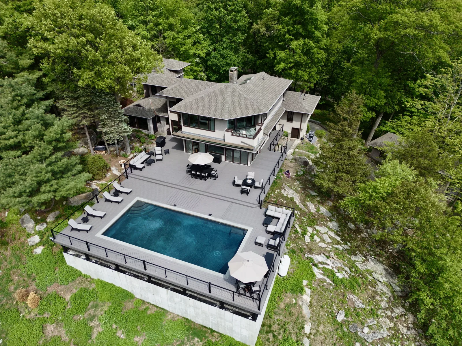 Aerial pool deck against Hudson Valley mountains
