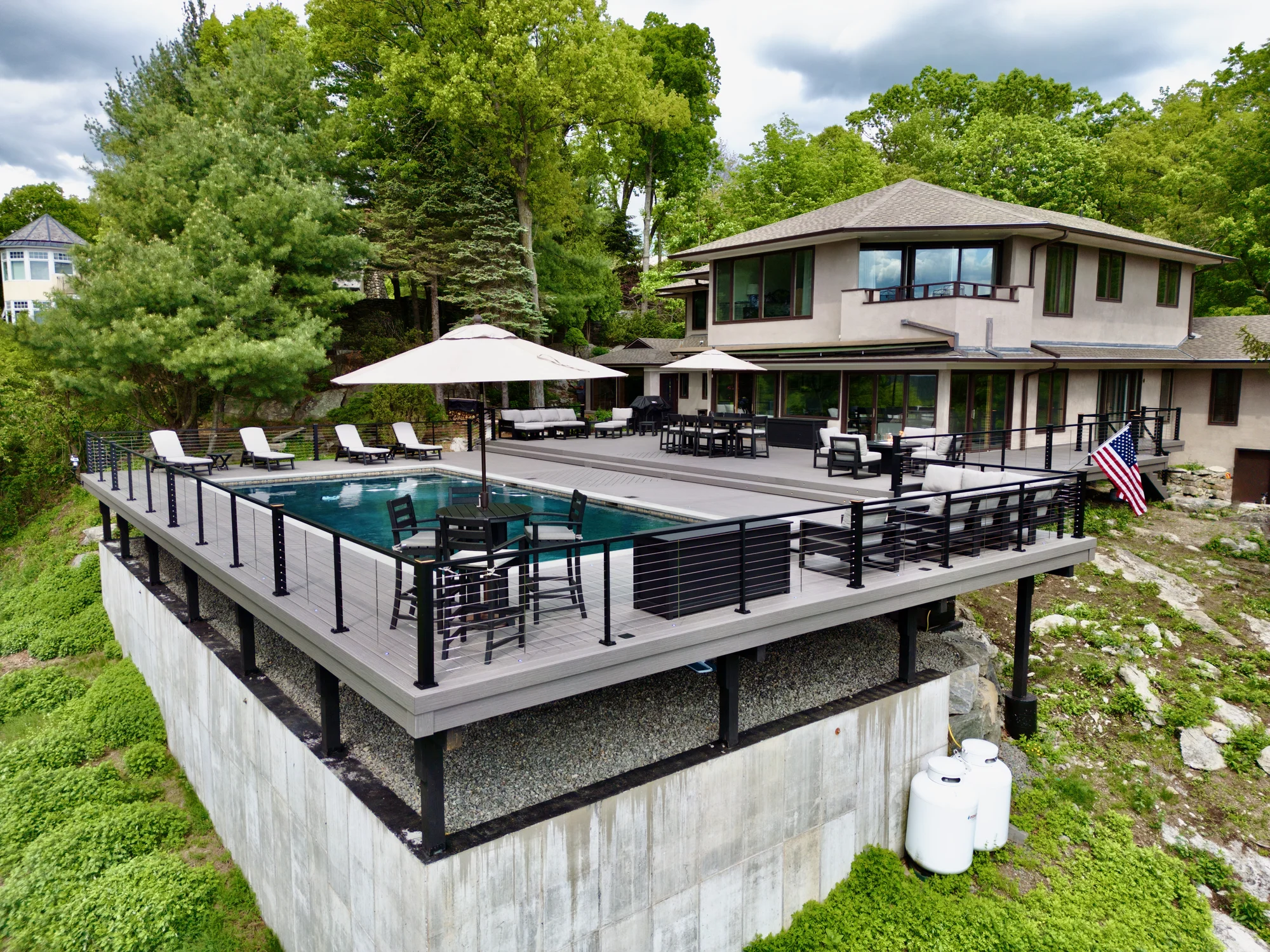 Pool deck with cable railing and a mountain view