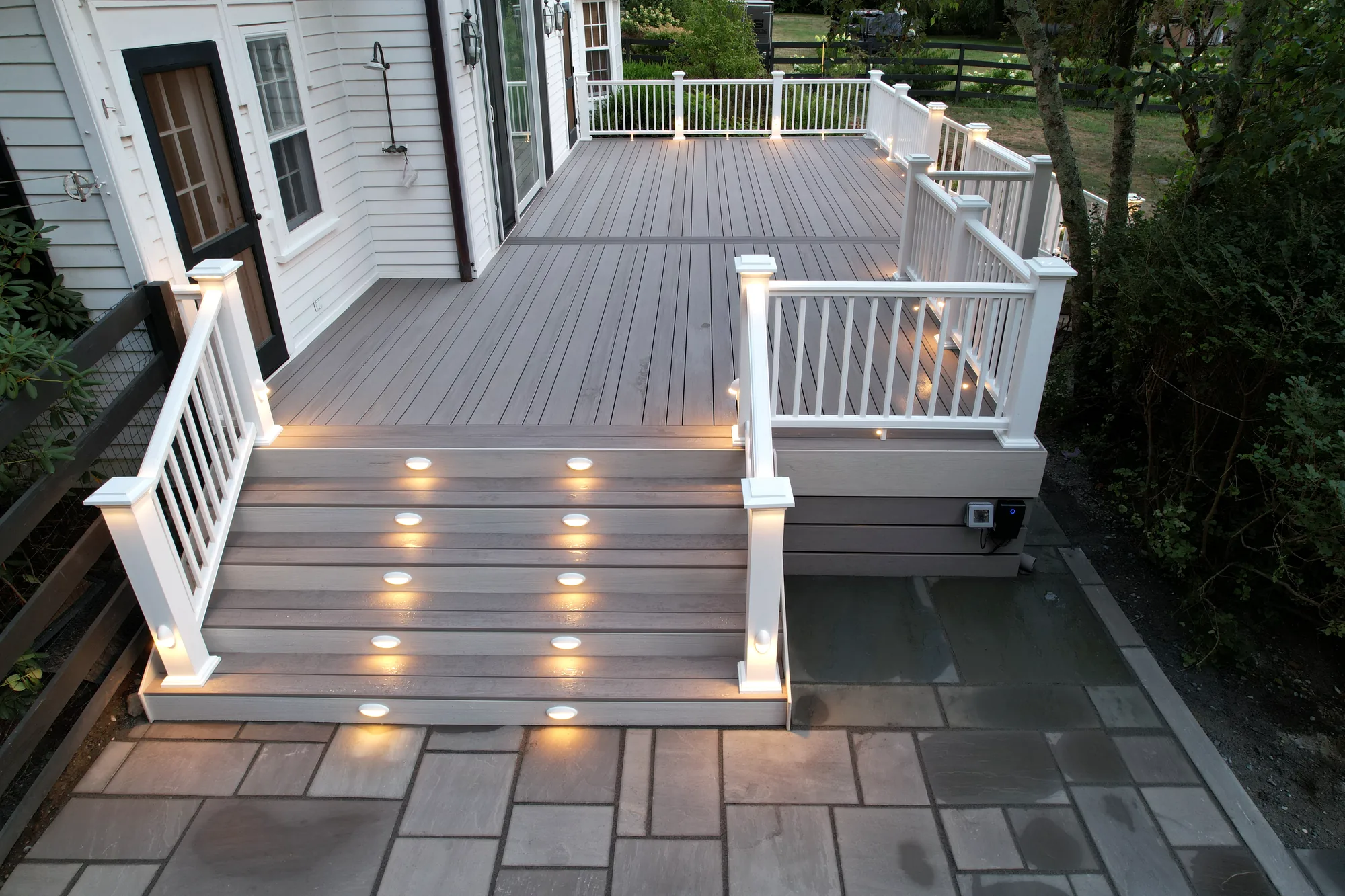 Architectural deck lighting detail at dusk in the Hudson Valley