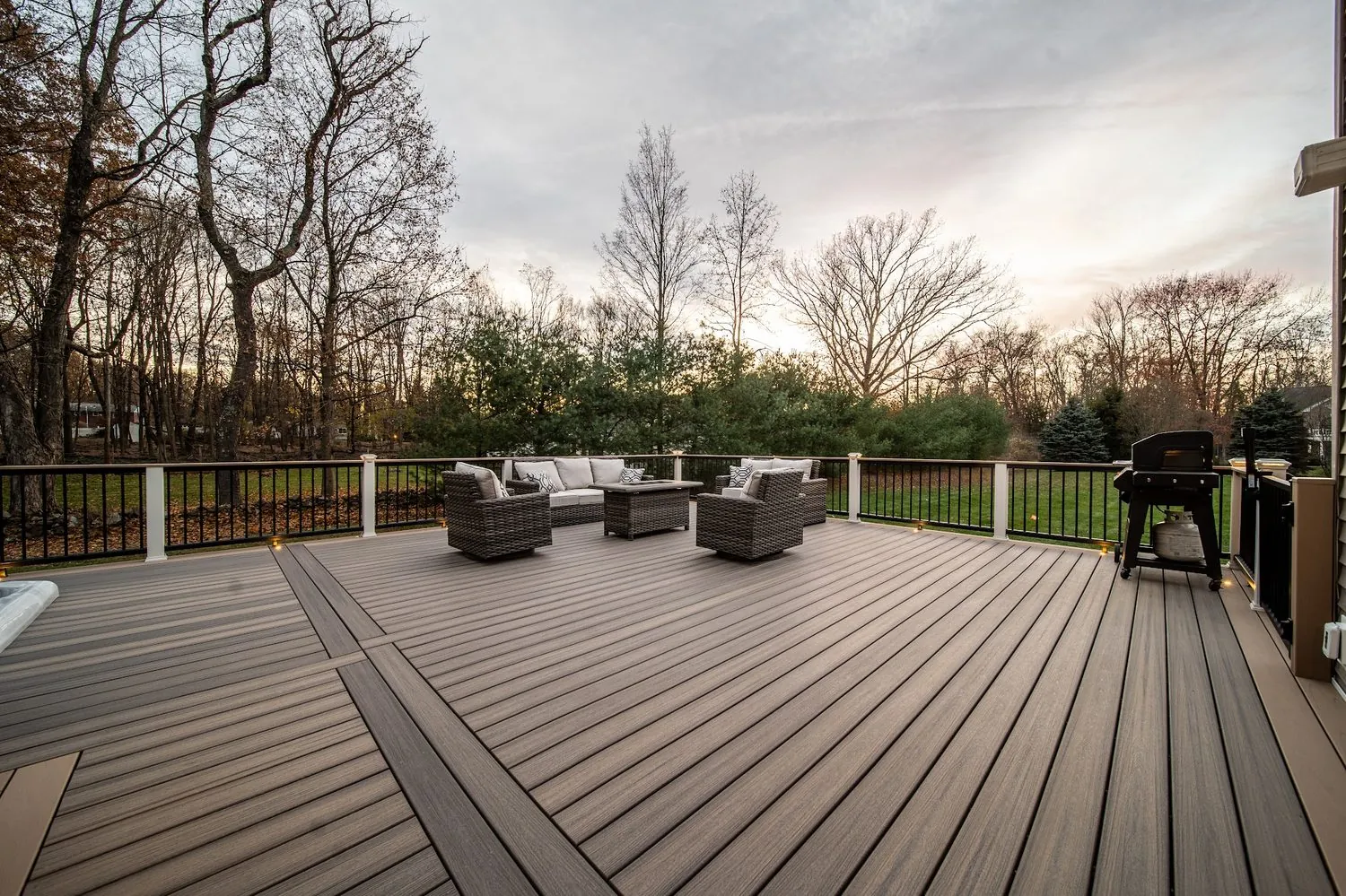 Luxury Trex deck with fire pit and evening lighting — Pinnacle Decking Hudson Valley NY